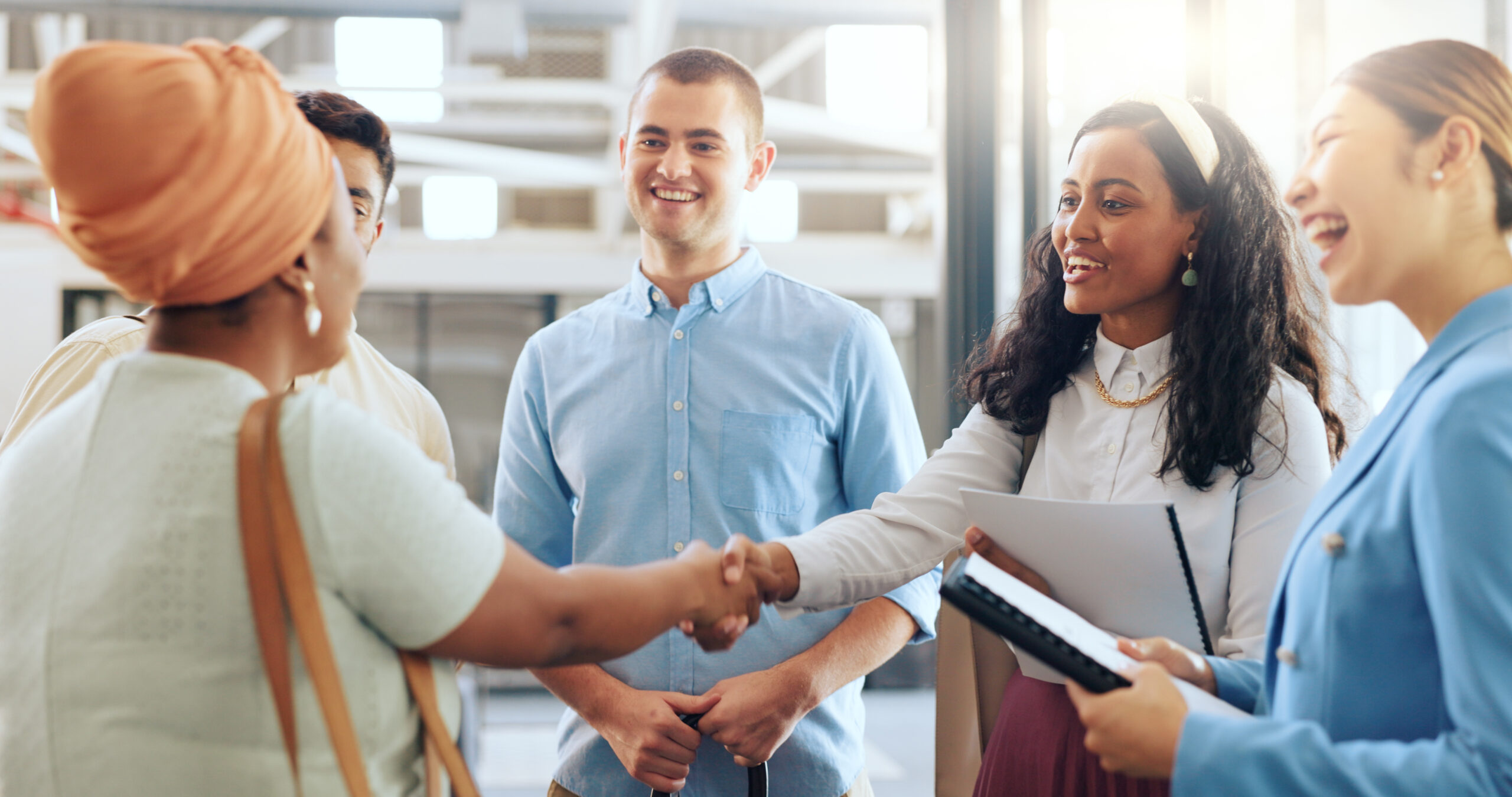 Diversity, team and handshake for partnership, business and collaboration in modern office. Teamwork, multiracial and staff greeting, hand gesture for welcome and group project for startup company.